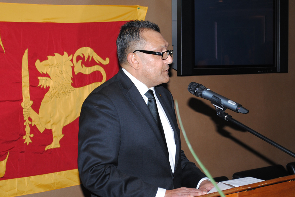 Man standing in front of microphone at a podium