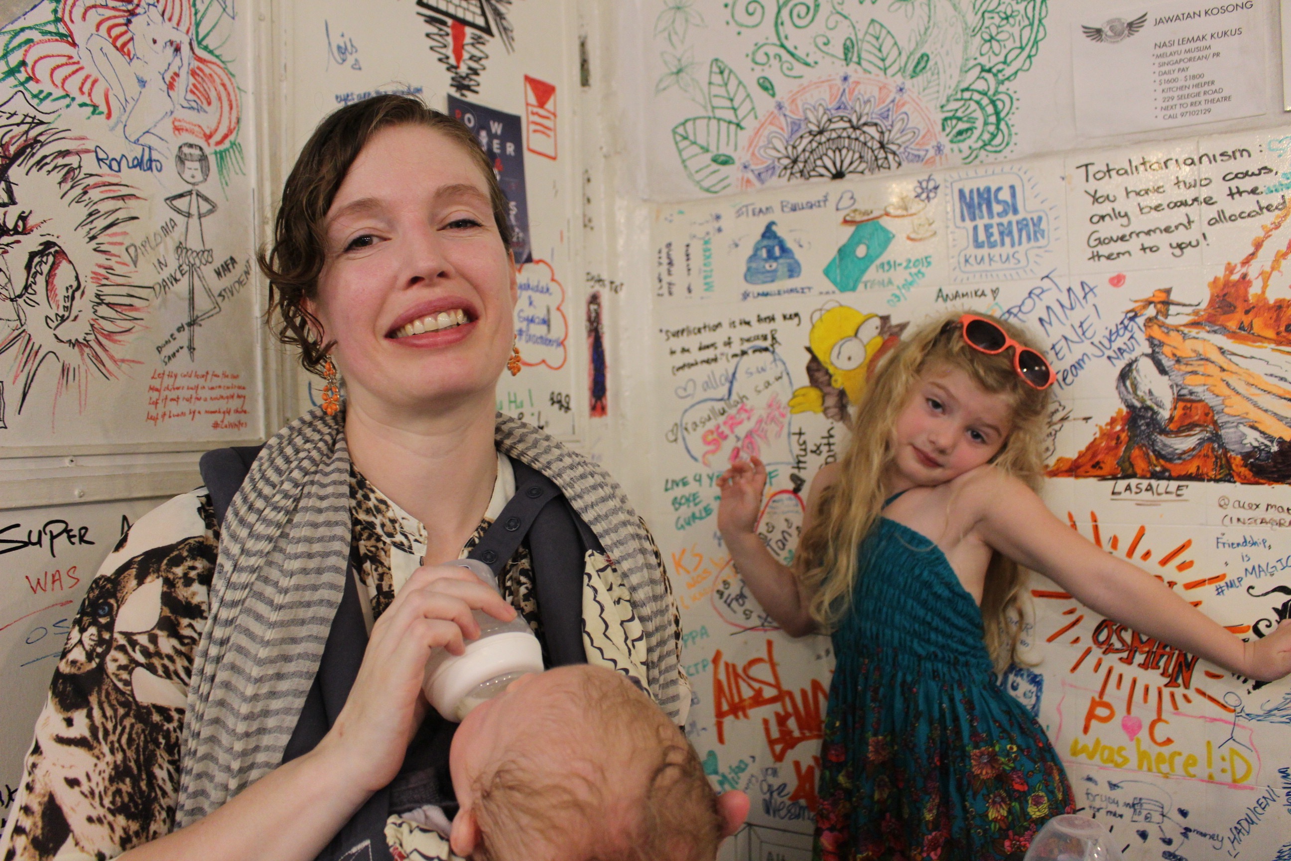 Sarah with her kids feeding one