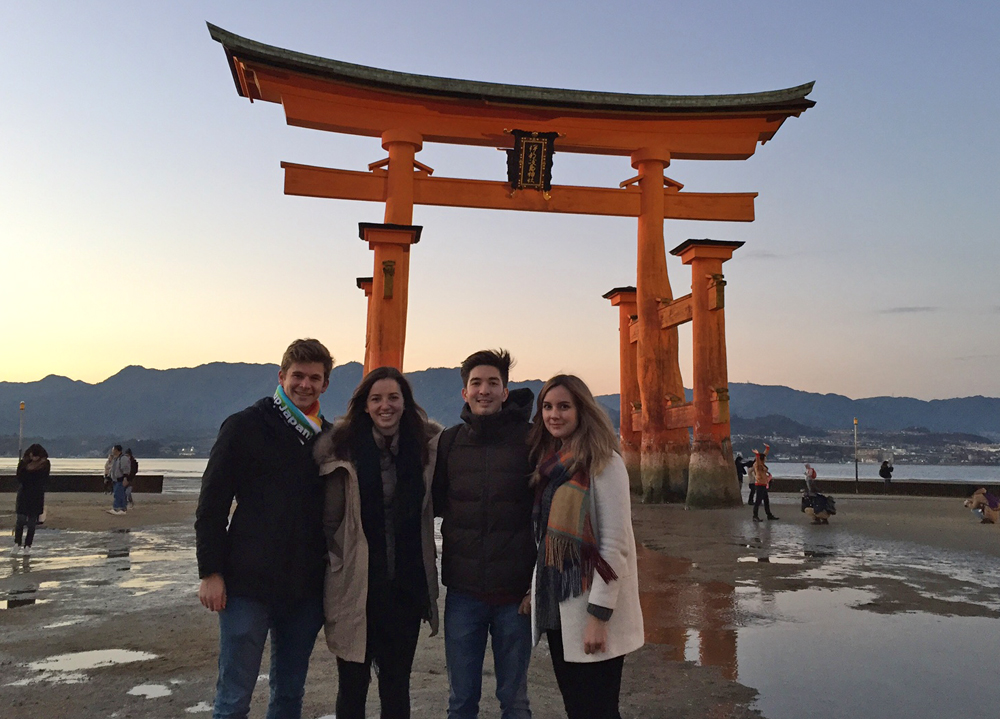 Four people standing in front of gate