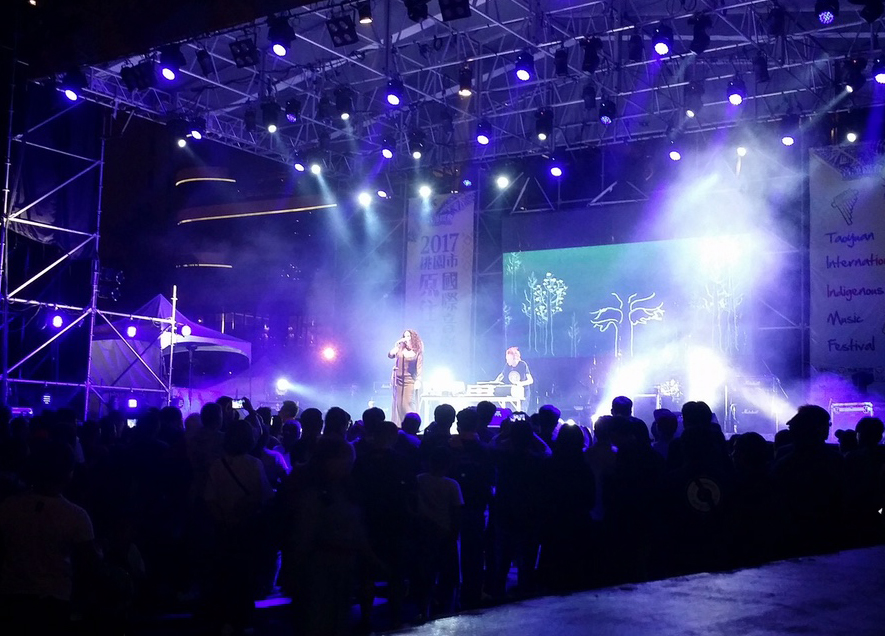 band performing live on stage with blue ights