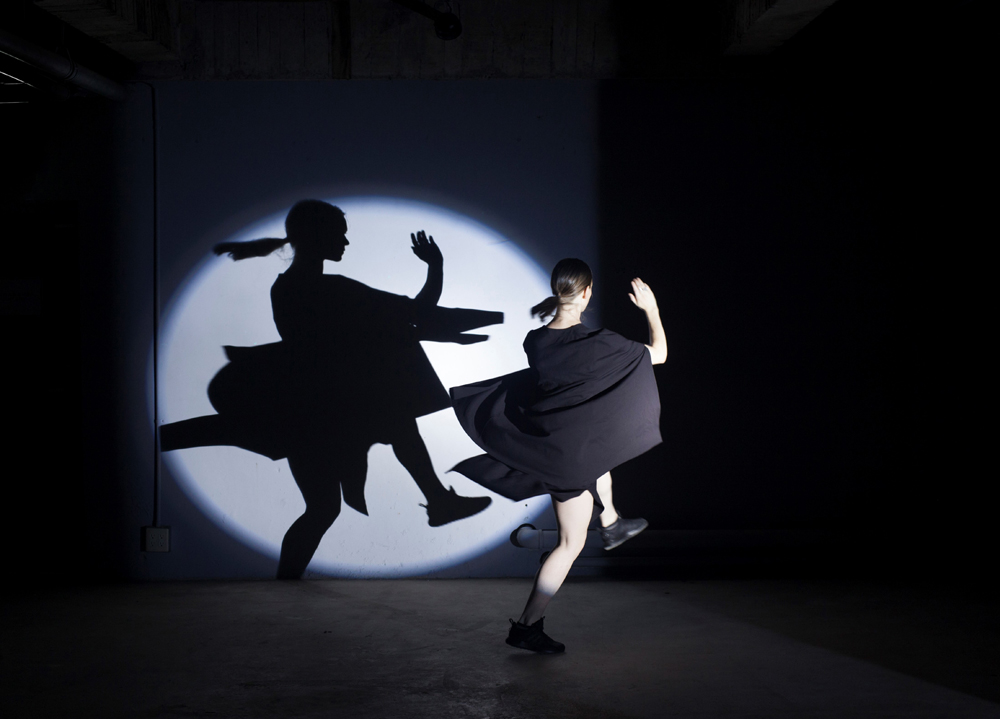 Woman spinning in front of spotlight at dance show
