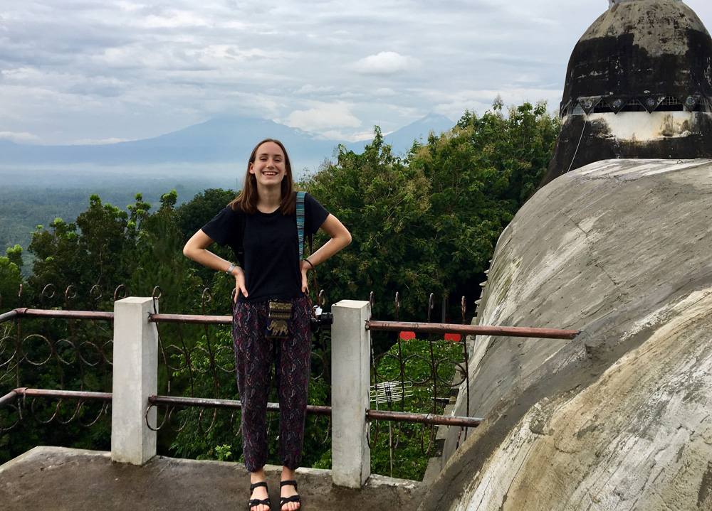 woman stands in front of picturesque back ground