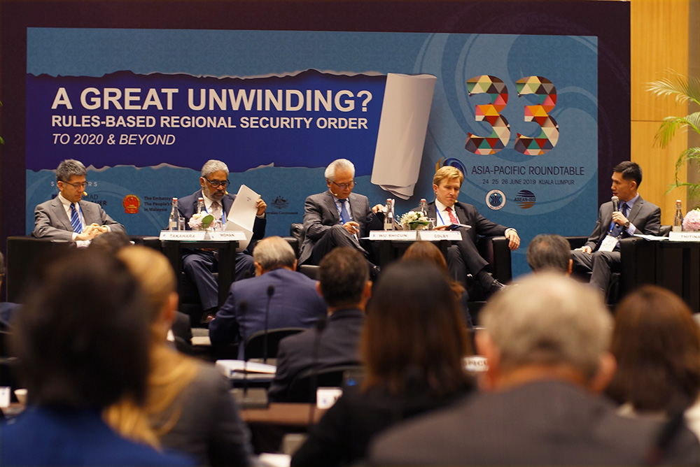 A panel discussion in an auditorium