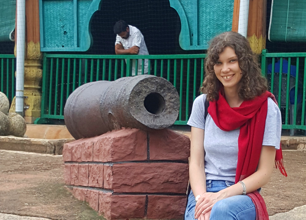 Eleanor Wenman sitting near an old canon