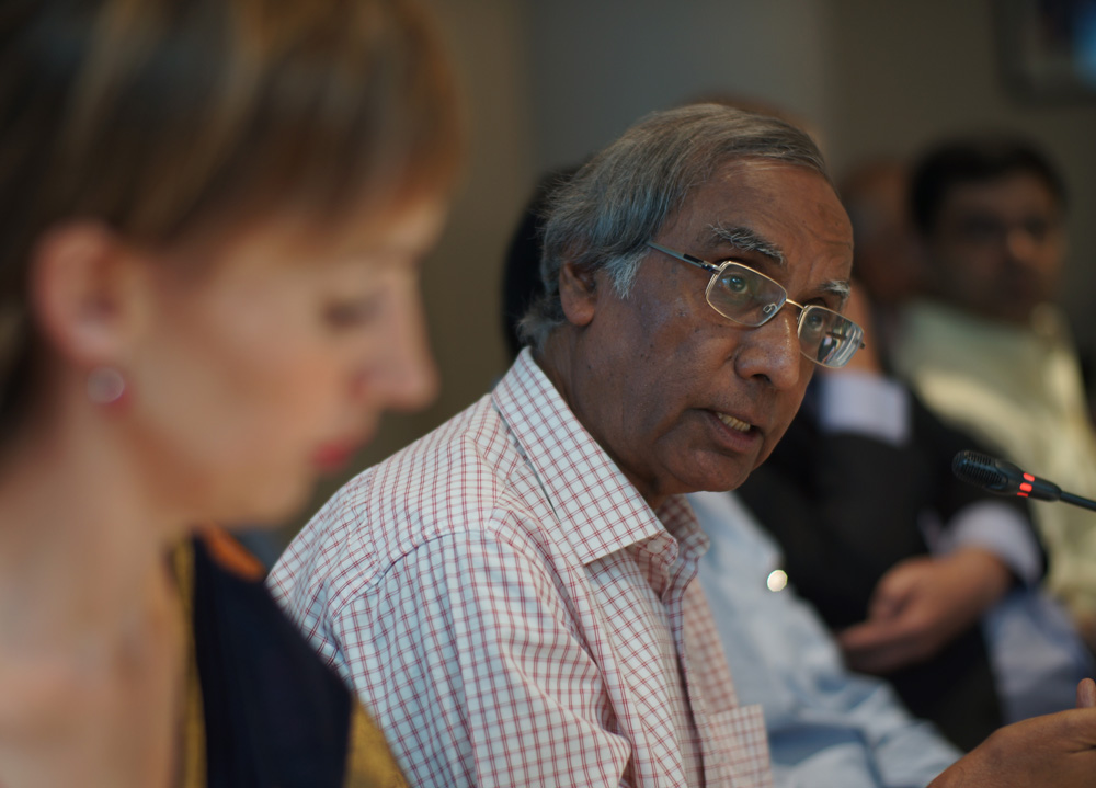 Man sits at table addressing room