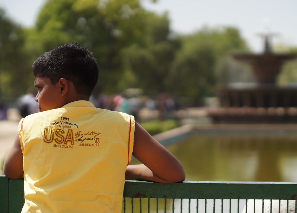 A boy looking over ridge railing