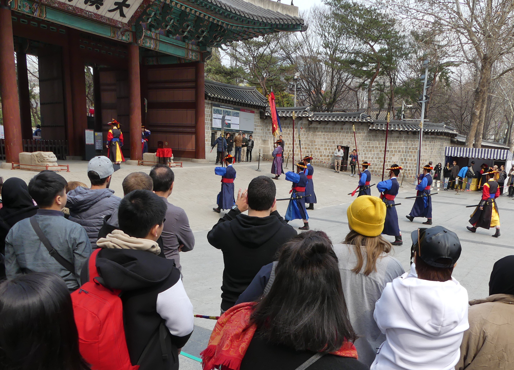 Group of people watching cultural event happen in front of them