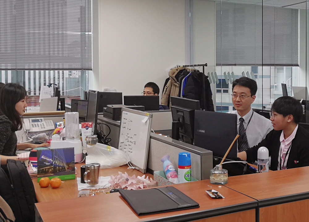 office workers sitting at their desks working hard