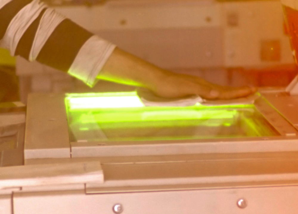 womans hand against photocopier