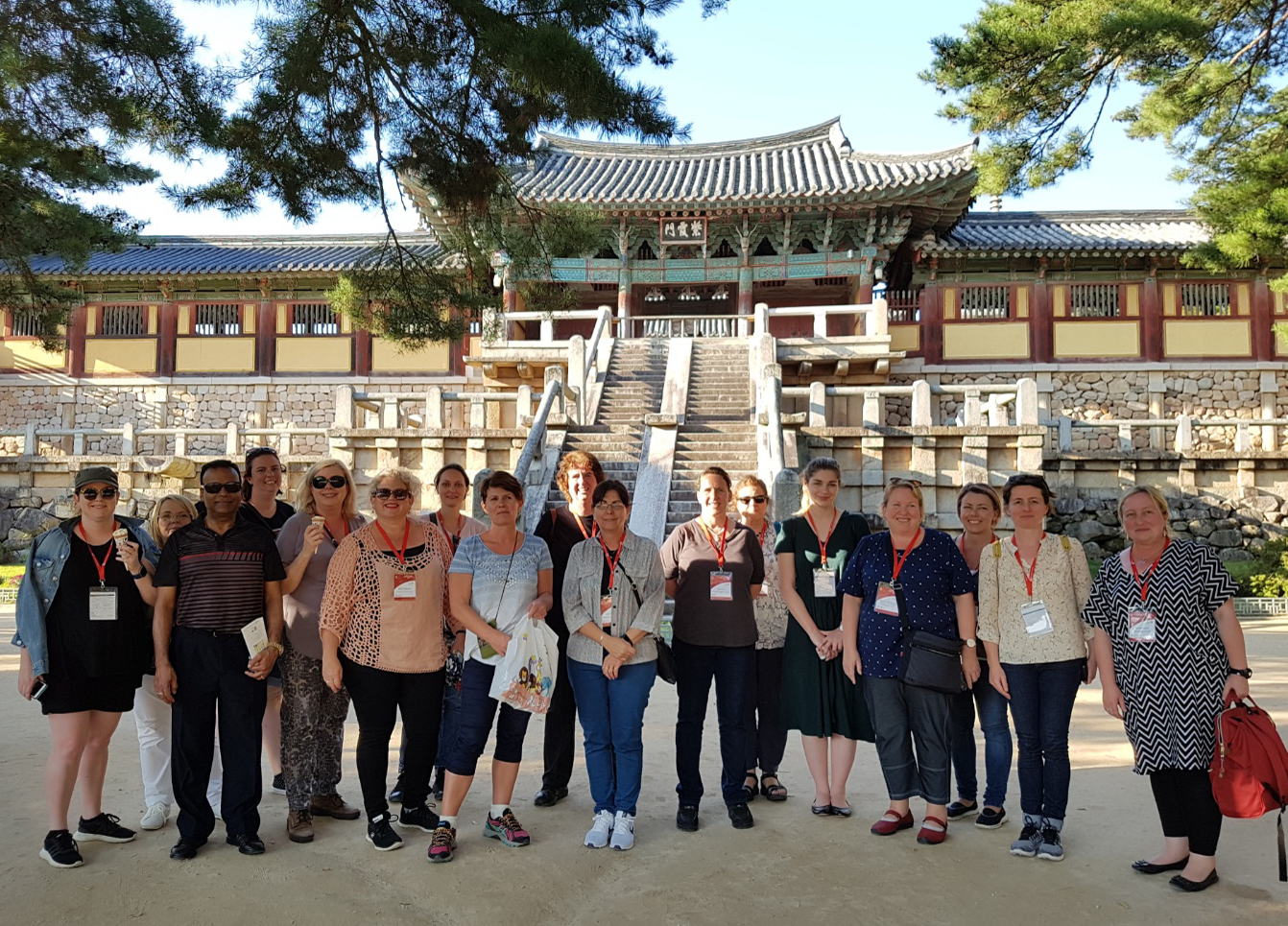Group of teachers standing in a line in front of a building
