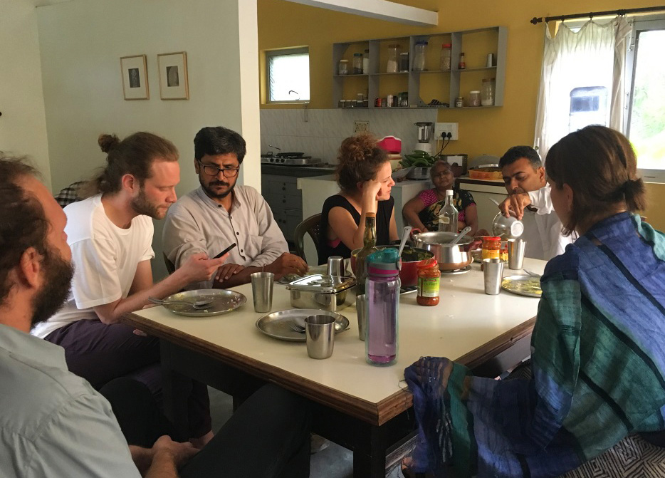 Group of people sitting around a table talking