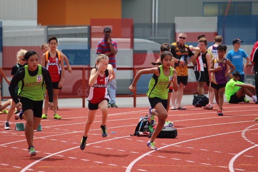Three girls running on a track