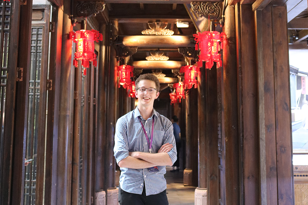 Pete standing in a hall with Chinese lanterns