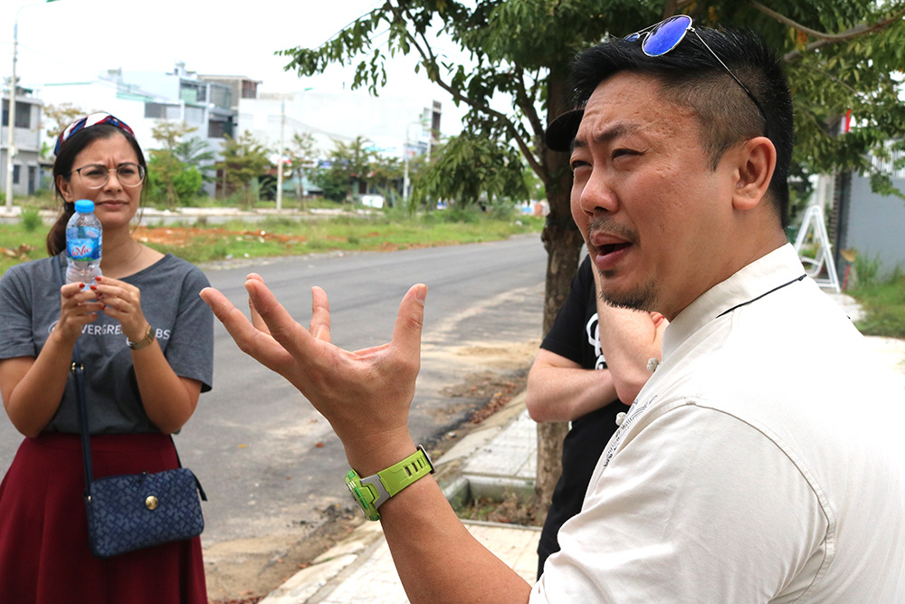 A man standing on a street chatting to people