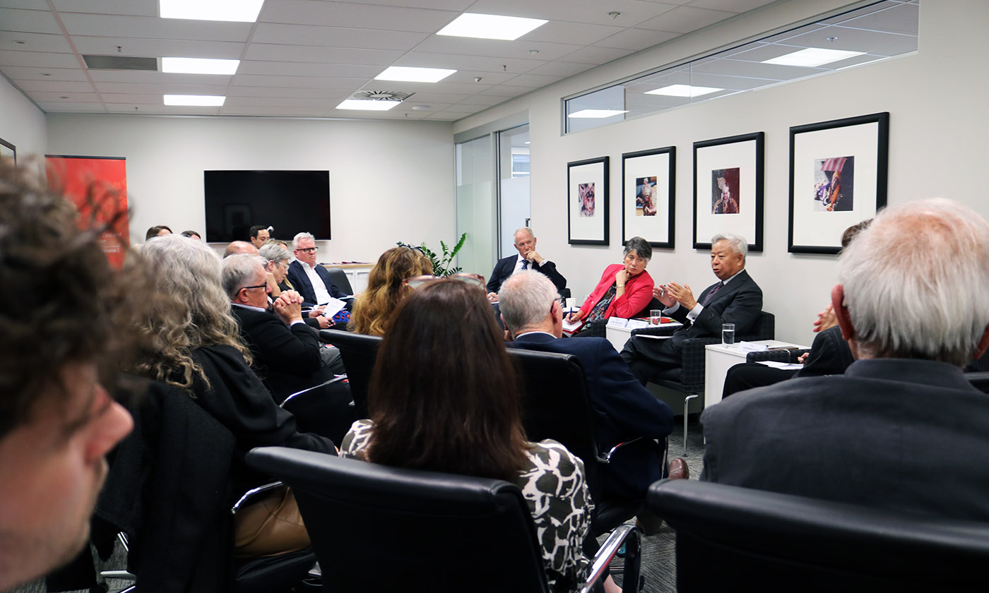 Three panellists speaking to a room