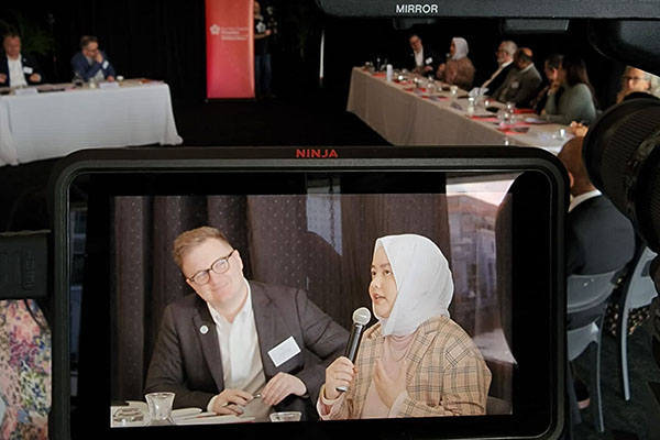 A sh preview screen showing a woman speaking into a microphoneot of a camera's