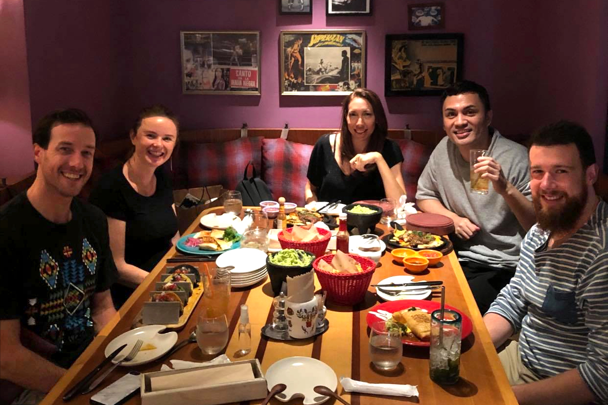The group sitting around a table at a restaurant