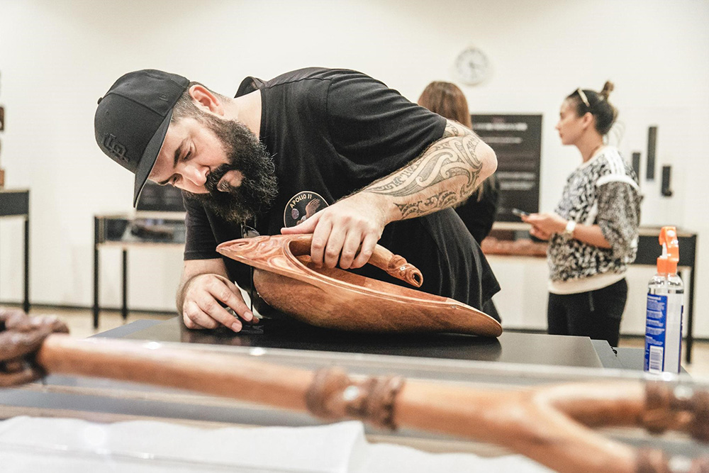 Karl installing a wooden carving