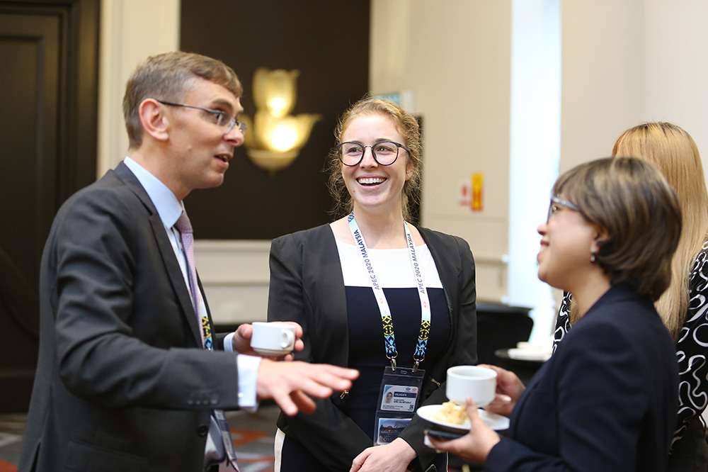 Klara at a formal event in a group chatting