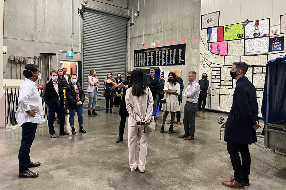 Jacob Rajan talking to a group of people in a theatre space