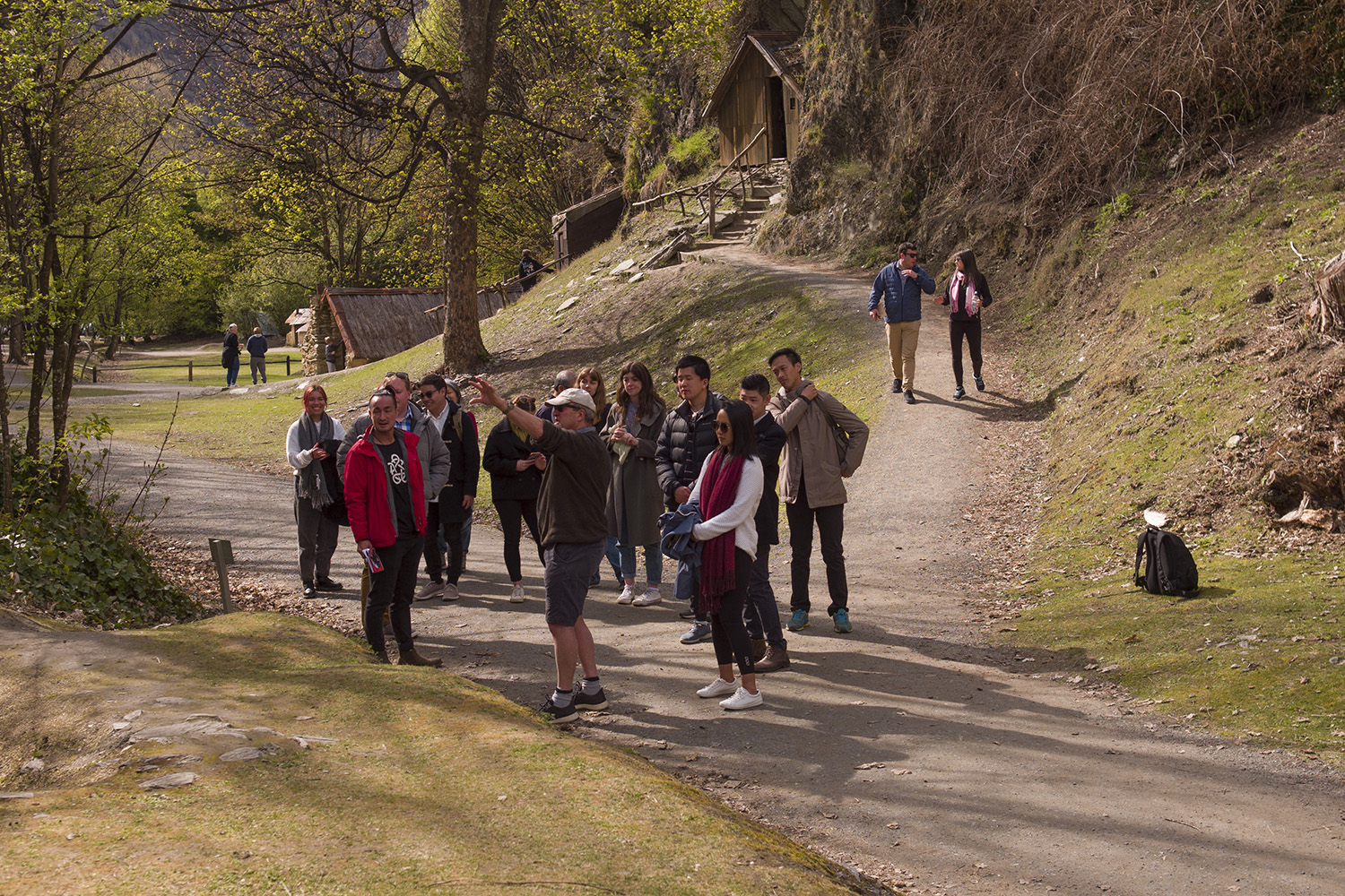 A man points out sidets to hui participants at the historic Chinese miners camp in Arrowtown