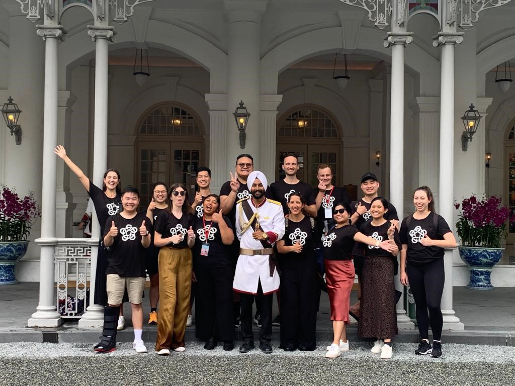 The Leadership Network member and Foundation staff pose with a ceremonial guard dressed in white