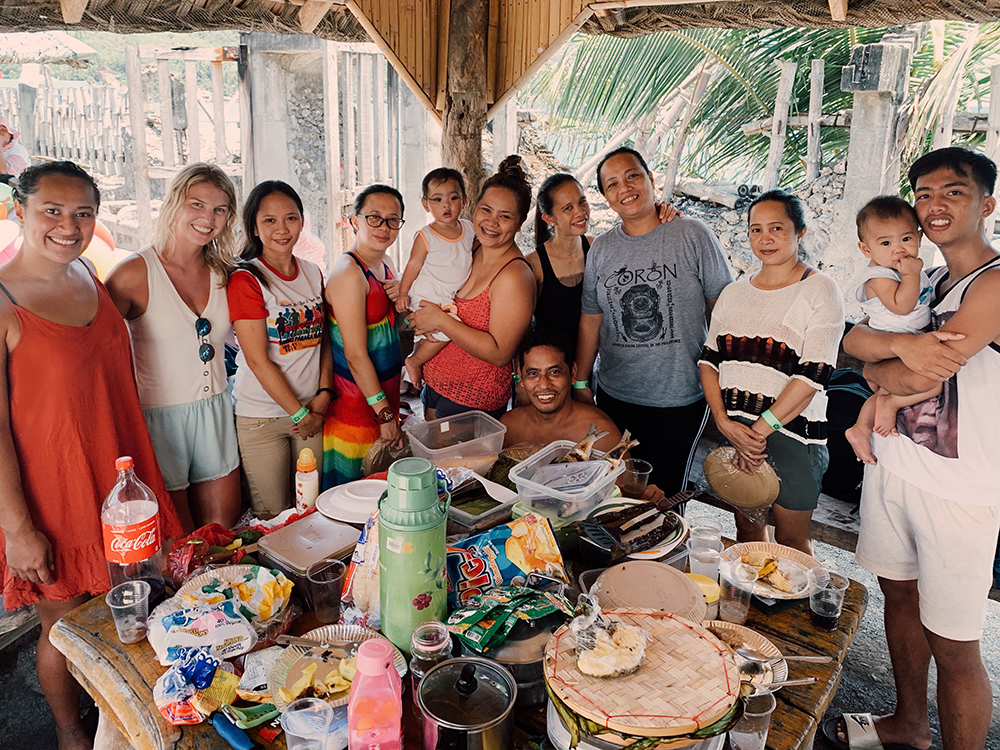 A large group of people gathered around a table after a meal
