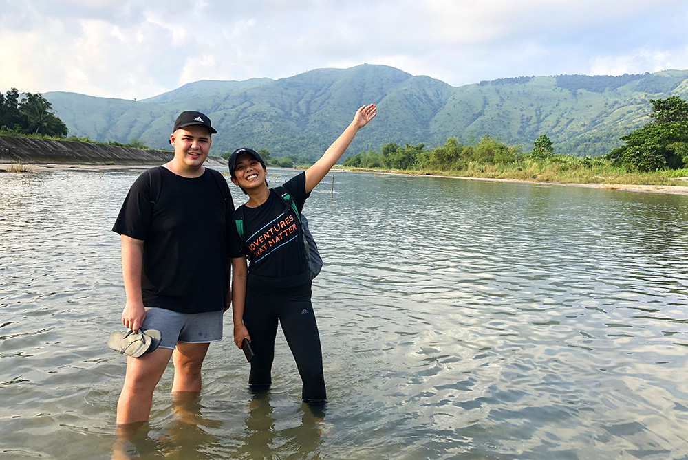 Tim and a colleague standing in a river