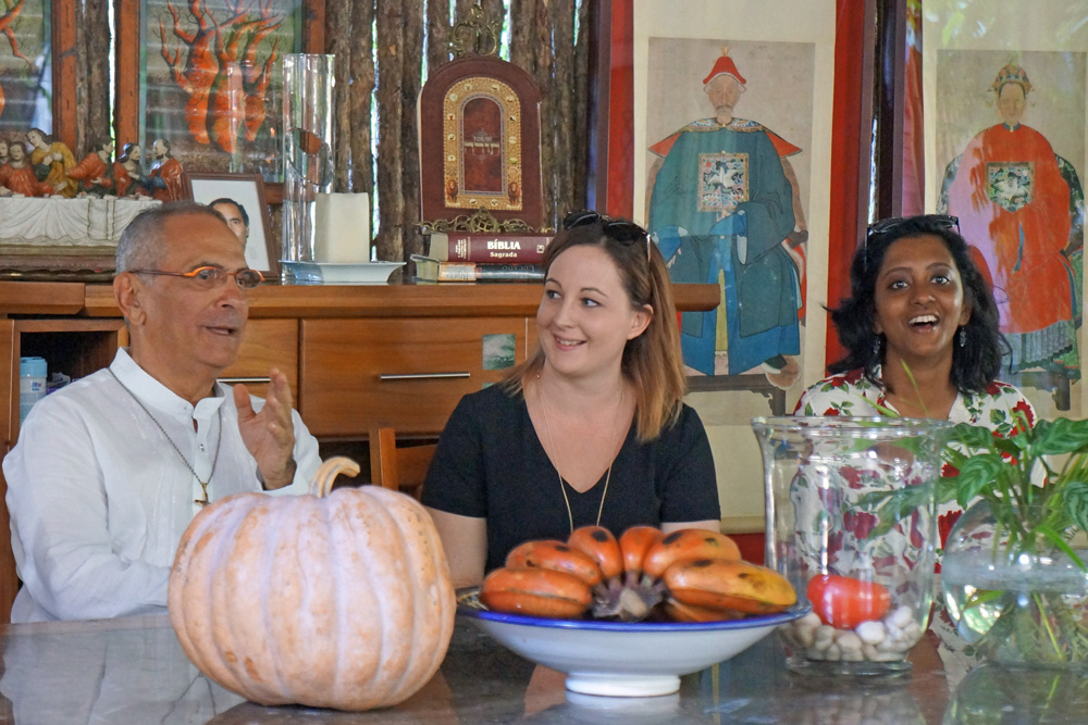 Three media people sit around a table talking