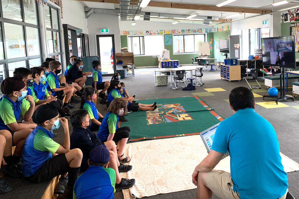 Students watching Sam on screen