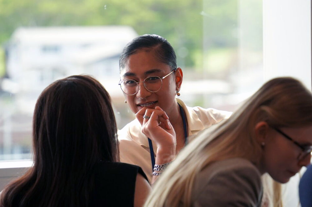 Seraphine engaged in a conversation with a fellow Leadership Network member