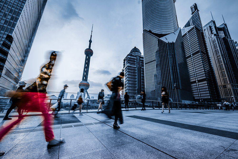 People walking in front of Shanghai's Orient Pearl Building