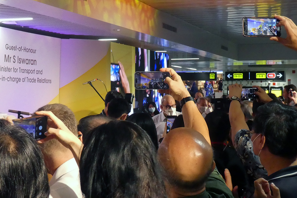A throng of people taking photos on their camera phones of Singapore transport minister