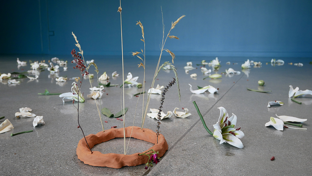 ceramic flowers sitting on concrete