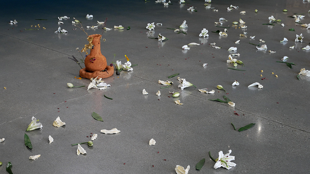 White cermaic flowers scattered on a concrete floor
