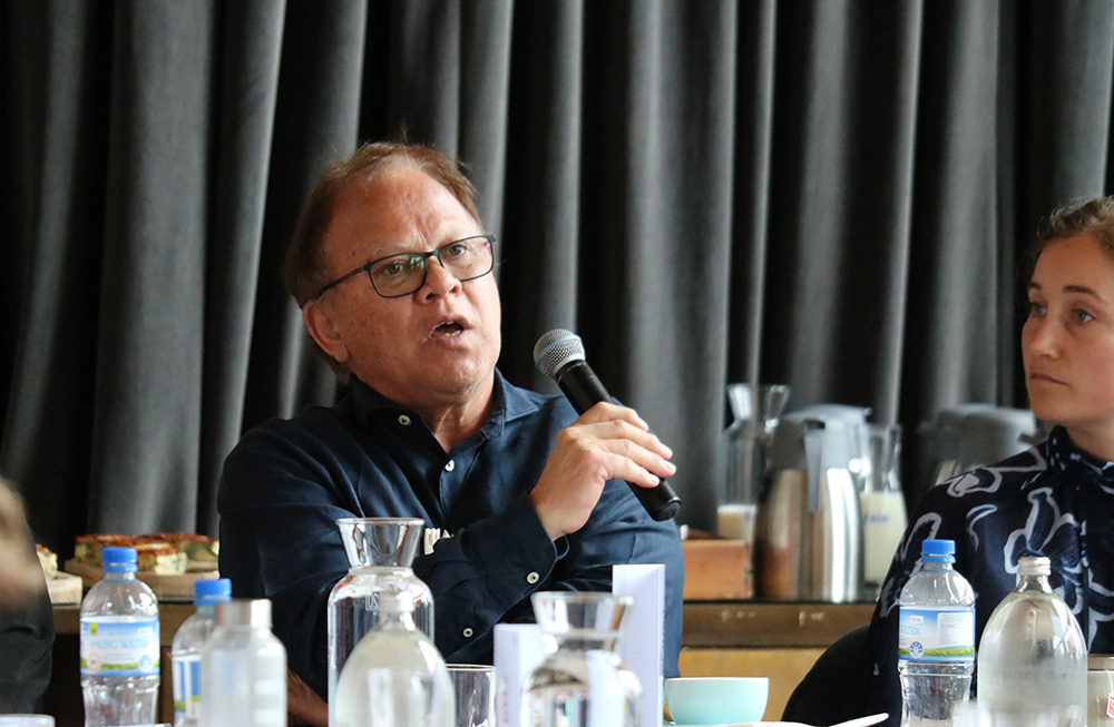 Paul Morgan speaking into a microphone at a meeting