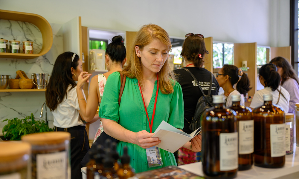 One of the entrepreneurs looking at a booklet in a health and beauty spa