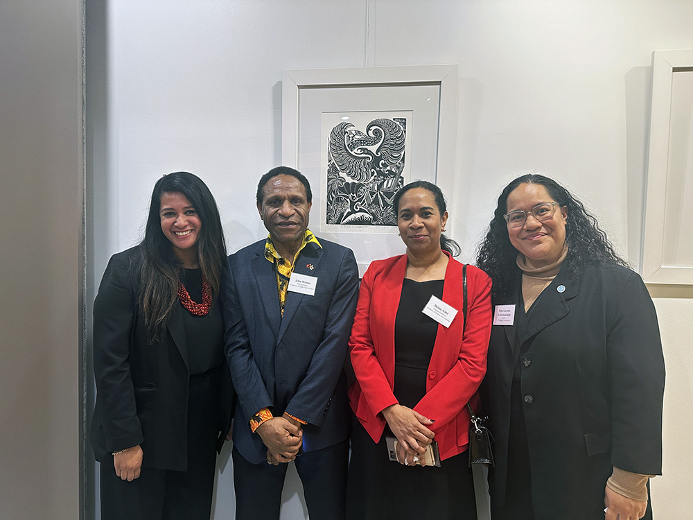 Fine with three other people standing in a room with a black and white picture behind them (at Waitangi Day celebrations at the NZ Embassy in Seoul)