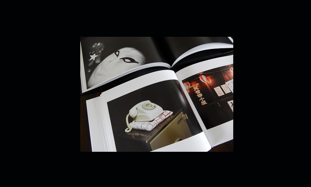 A photo of a magazine open to a page showing a photo of an old telephone