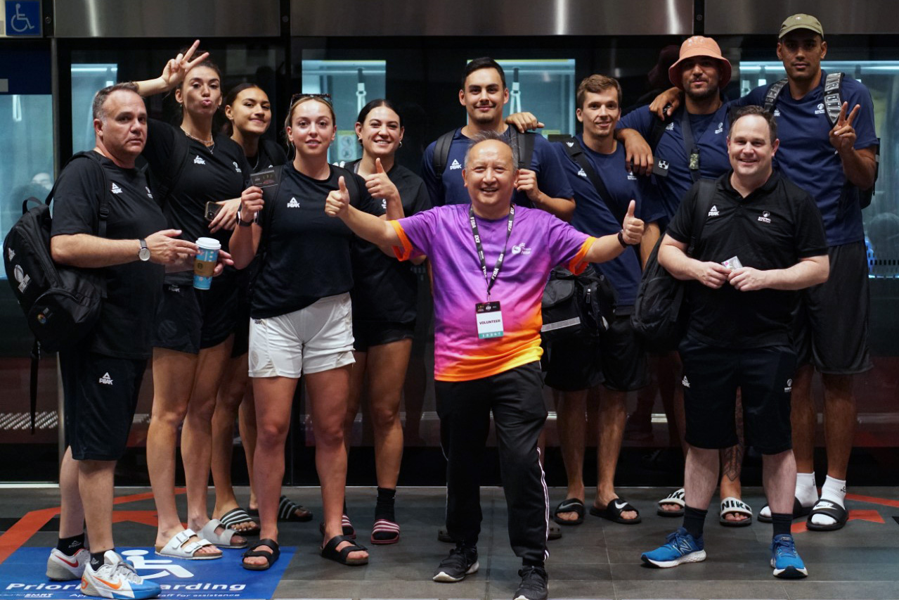 The two teams and management posing for a photo