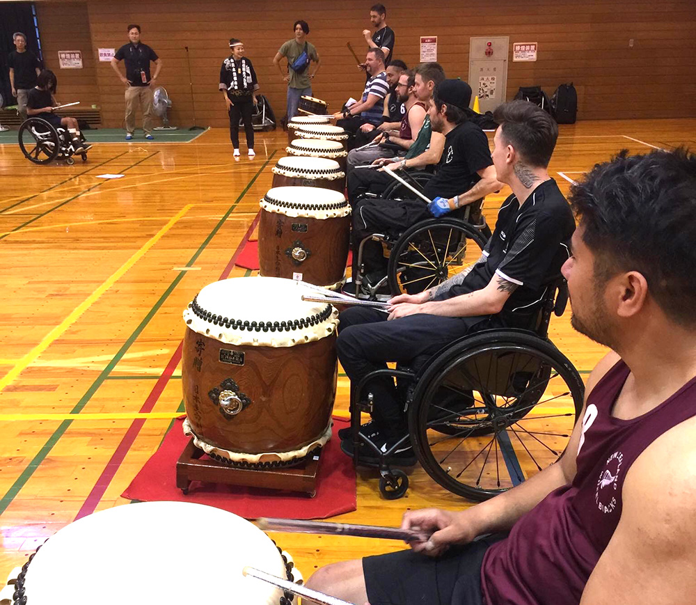 A line of Wheel Blacks practising taiko drumming