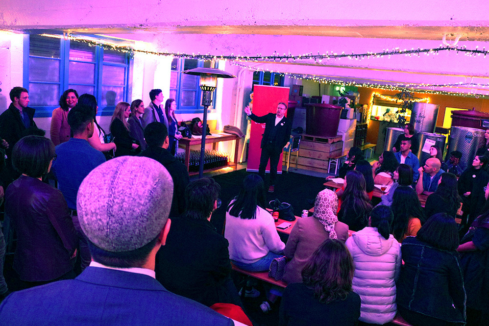 Simon speaking to a gathering of the Foundation's '25 to Watch and Leadership Network members