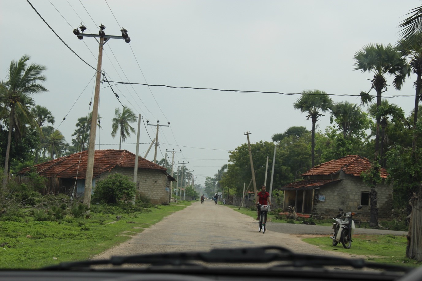 Looking out the windscreen of a car at a rural road