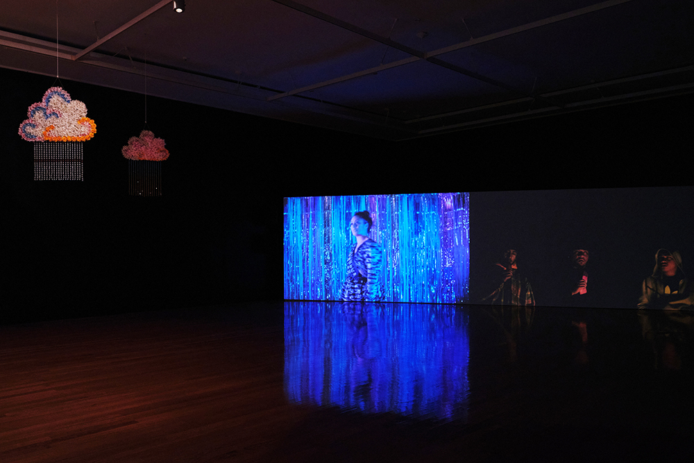 A photo in a gallery showing a woman on a screen