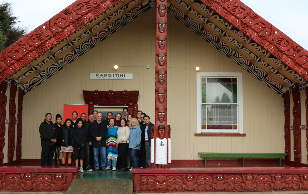 Foundation staff, Leadership Network members and kaumatua from Rangitihi marae standing in front of the whare nui