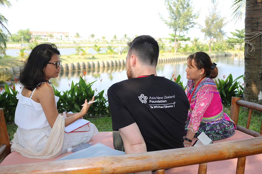 Michael sitting outside chatting to two fellow entrepreneurs