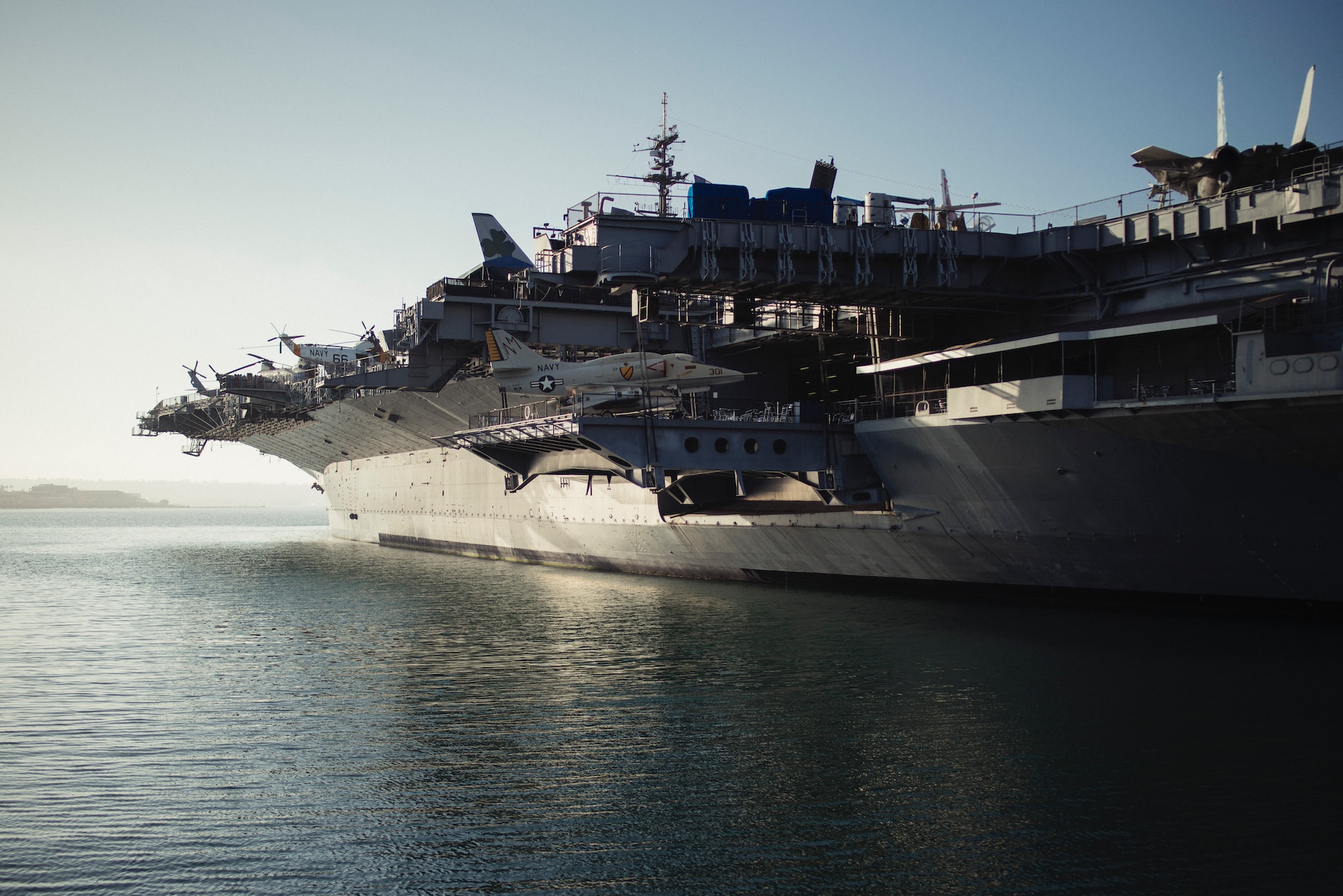 A jet fighter being loaded onto an aircraft carrier