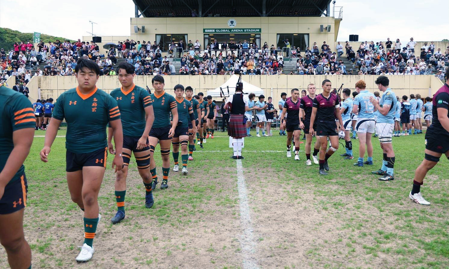 Hamilton Boys High 1st XV coming onto the field alongside a Japanese team