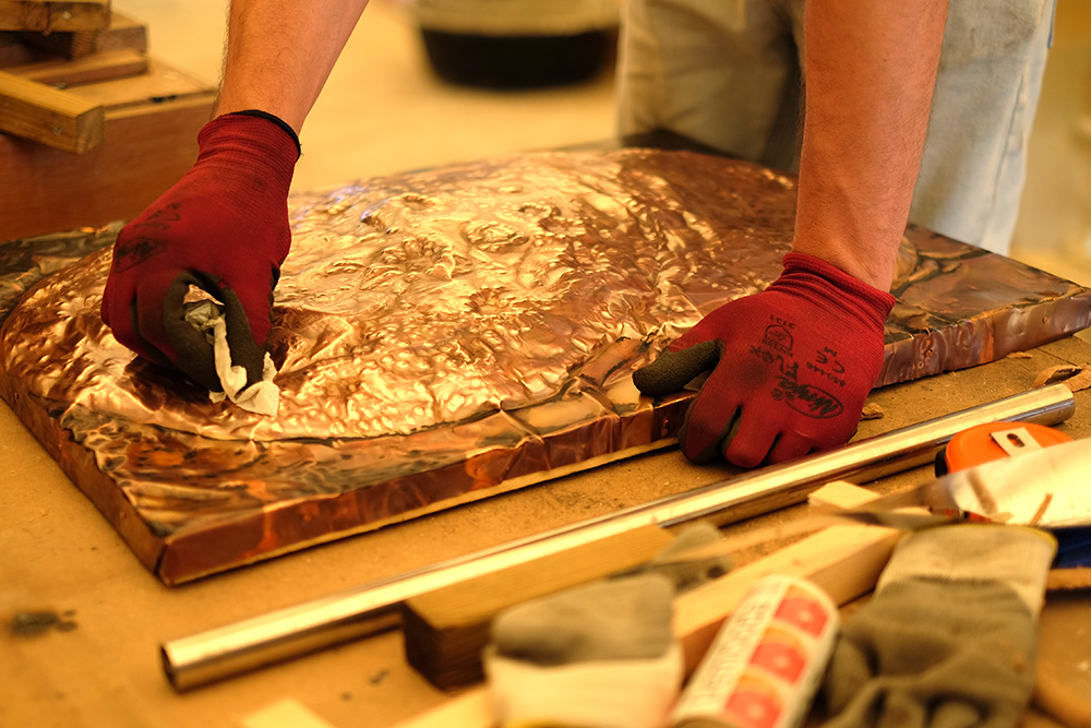Sam working on a copper art work