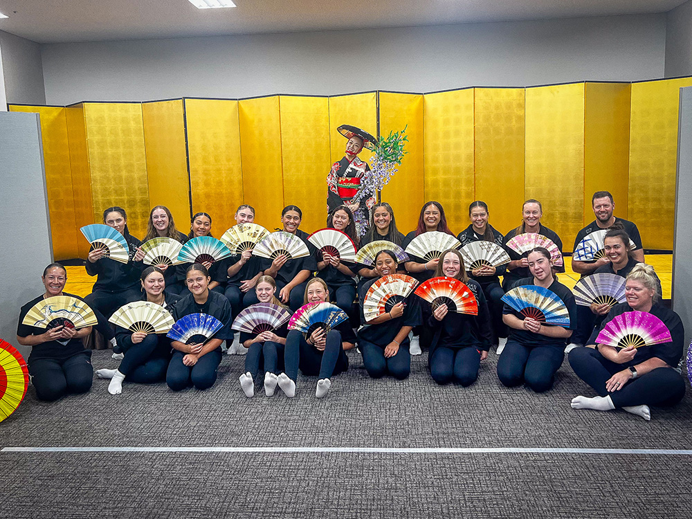 The Developing Sox softball team posing with colourful kempo fans